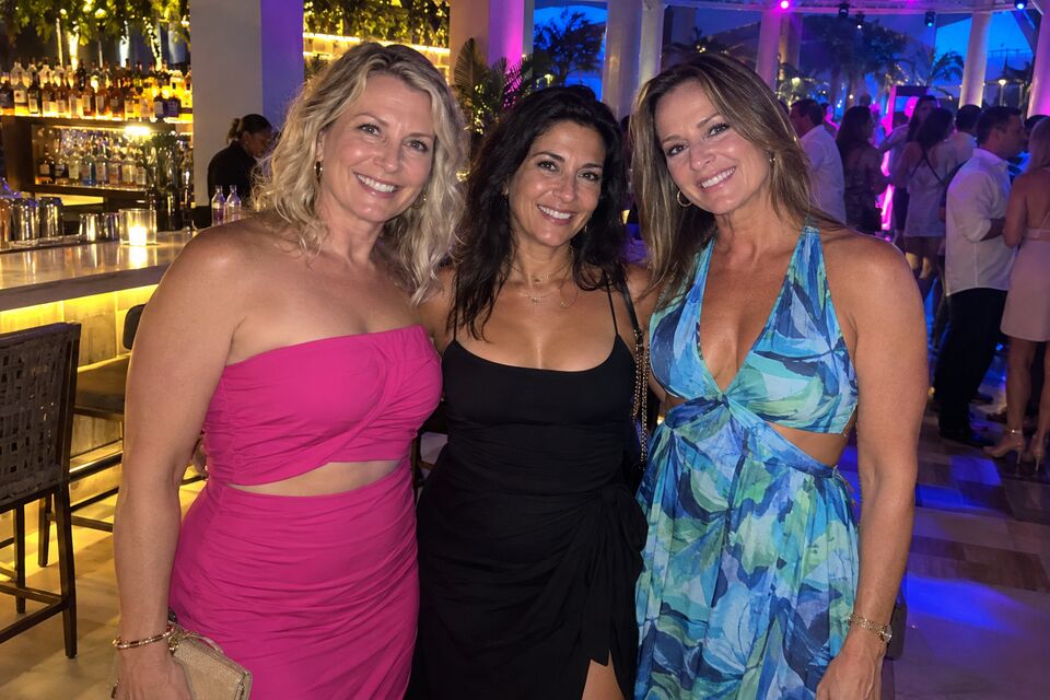 AI-generated illustration of three women friends smiling at the camera in a resort nightclub